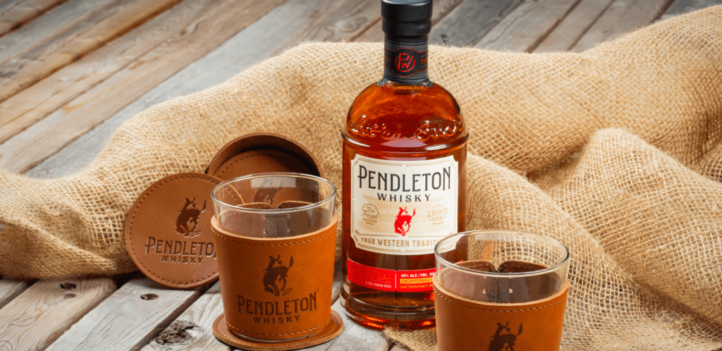 A bottle of Pendleton Whisky Original with coasters and leather wrapped glasses